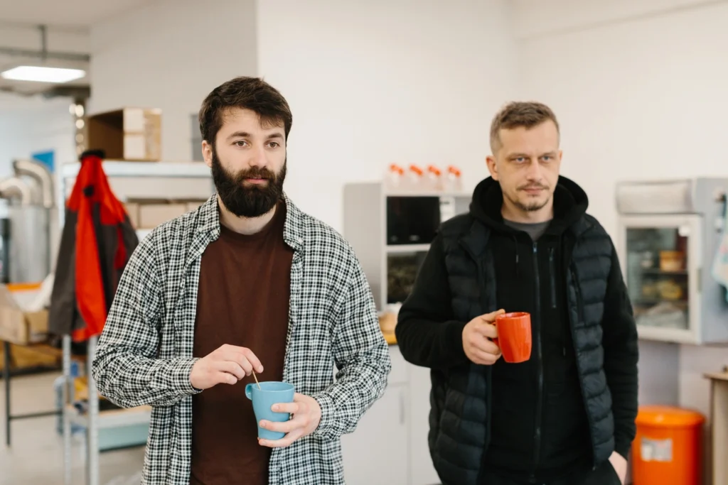 Two employees having coffee during a break in a workplace