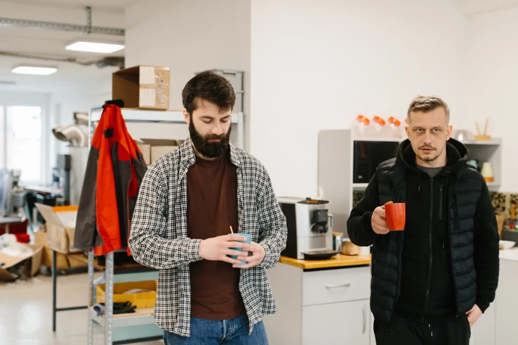 Two employees having coffee during a break in a workplace